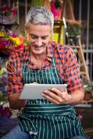 Male florist using digital tablet