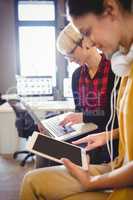 Two female graphic designer using digital tablet and laptop