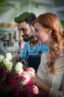 Happy couple arranging flowers