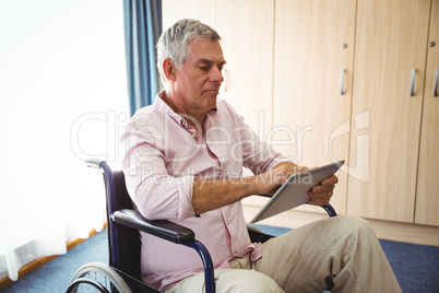 Senior using a tablet in a wheelchair