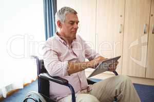 Senior using a tablet in a wheelchair