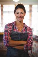 Waitress standing with arms crossed
