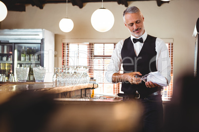 Bartender cleaning wineglass