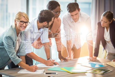 Group of business people discussing at desk