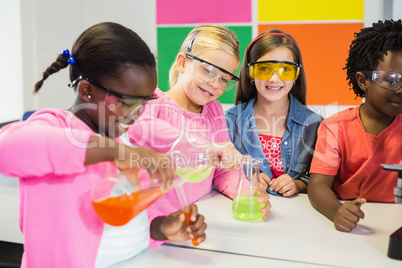 Kids doing a chemical experiment in laboratory