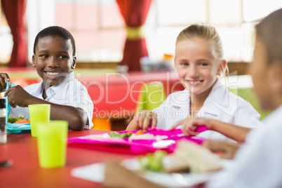 Children having lunch during break time in school cafeteria
