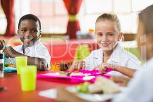 Children having lunch during break time in school cafeteria