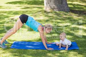 Woman exercising with her baby