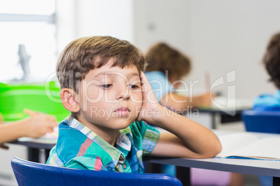 Thoughtful boy looking away while studying