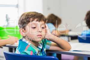 Thoughtful boy looking away while studying