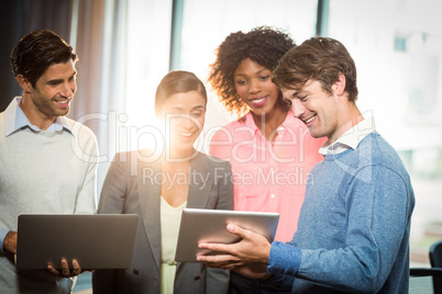 Business people having discussion over digital tablet