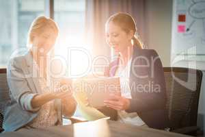 Businesswomen interacting using digital tablet and mobile phone