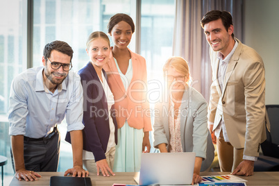 Group of business people interacting using laptop