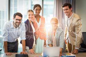 Group of business people interacting using laptop