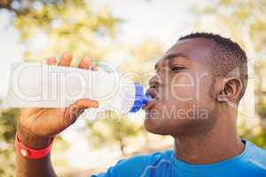 Athletic man drinking water