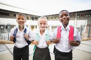 Smiling school kids standing in school terrace