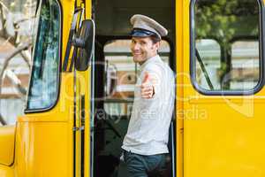 Bus driver showing thumbs up while entering in bus