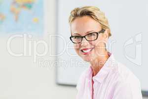 Portrait of teacher smiling in classroom