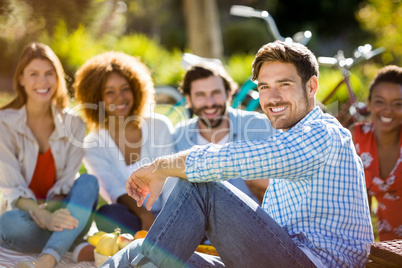 Man sitting with his friends in park