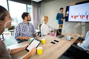 Business people discussing over graph during a meeting