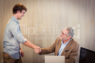 Businessman shaking hands with a coworker