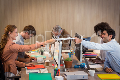 Businessman passing a file to his colleague