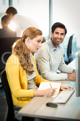 Man working with the coworker