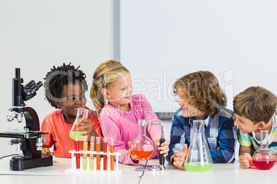 Kids doing a chemical experiment in laboratory