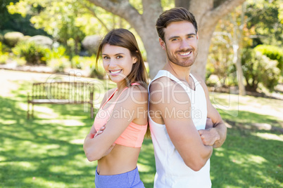 Portrait of couple standing back to back