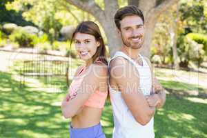 Portrait of couple standing back to back