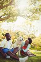 Couple posing with a dog