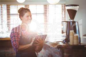 Waitress writing in a book