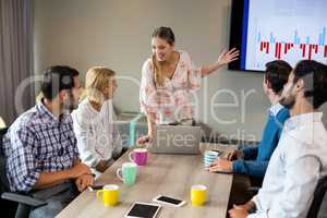 Business people discussing over graph during a meeting