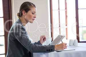 Woman using tablet and notebook