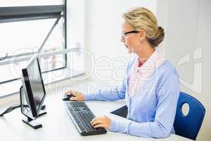 Teacher working on computer in classroom