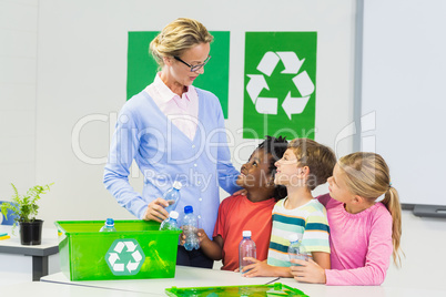 Teacher and kids interacting with each other in classroom