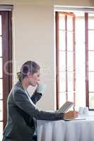 Woman working and drinking a coffee