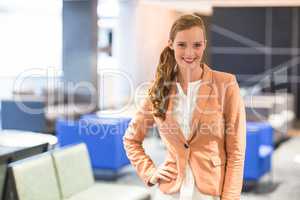 Beautiful young businesswoman standing in office
