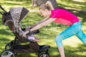 Woman exercising with baby stroller
