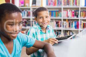 Kids using digital tablet in library