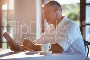 Man using tablet and notebook