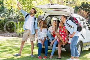Group of friends taking a selfie from trunk of car