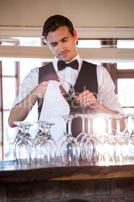 Bartender cleaning wineglass
