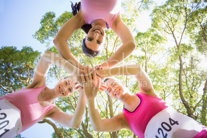 Young athlete women forming hands stack