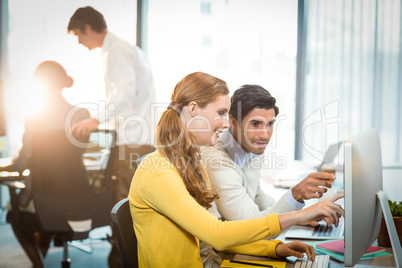 Executives working on laptop and computer