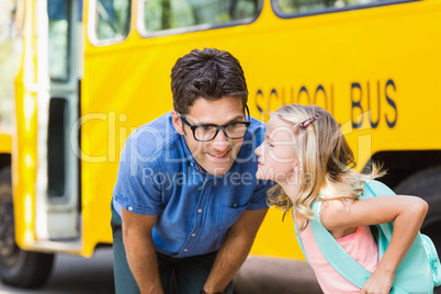 Schoolgirl about to kiss a teacher in front of school bus