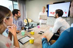 Business people discussing over graph during a meeting