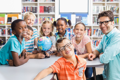 Portrait of teacher and kids in library