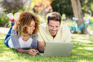 Woman watching while man using laptop