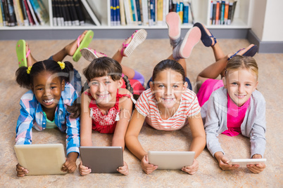 Kids using digital tablet in library